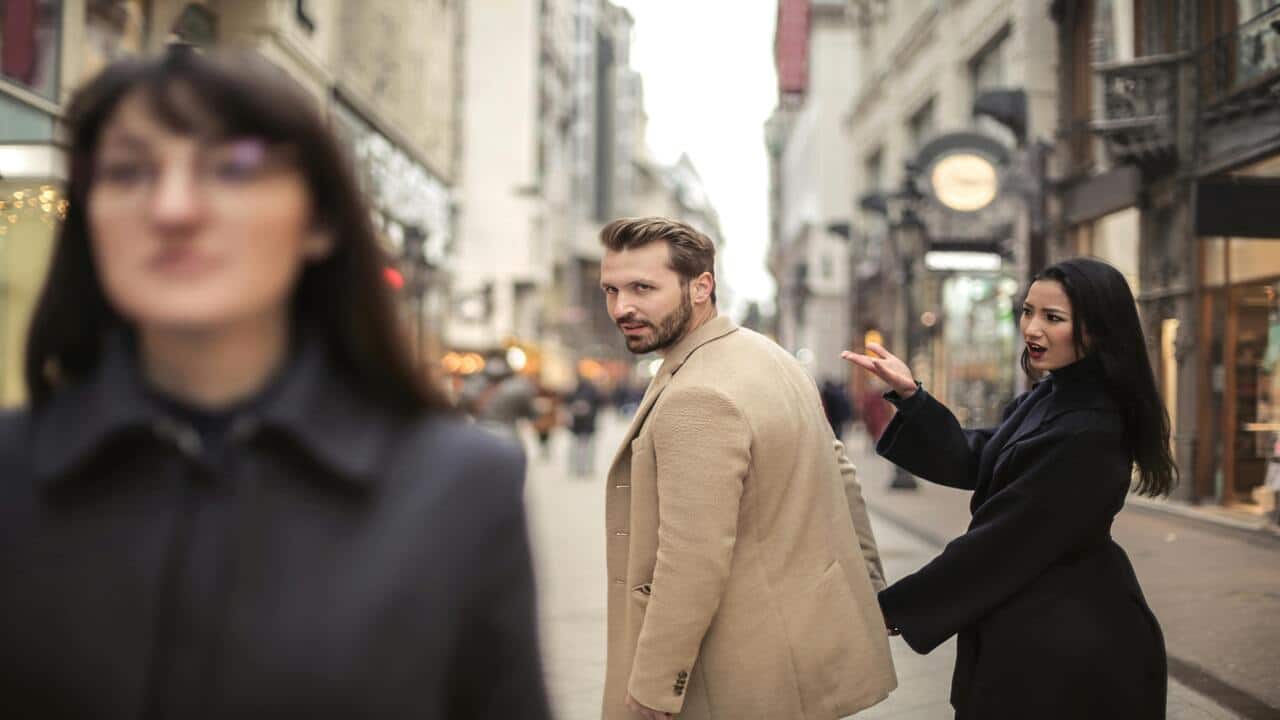 A man looking at another woman.