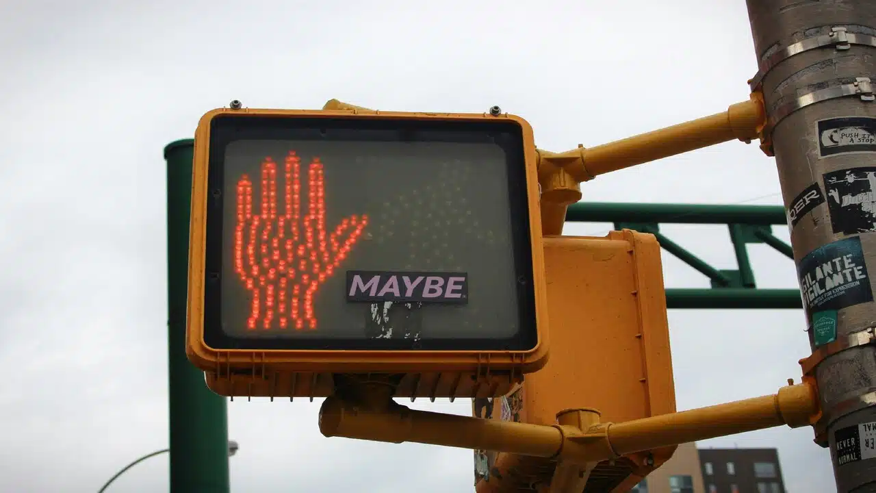The word “maybe” on a red traffic light.