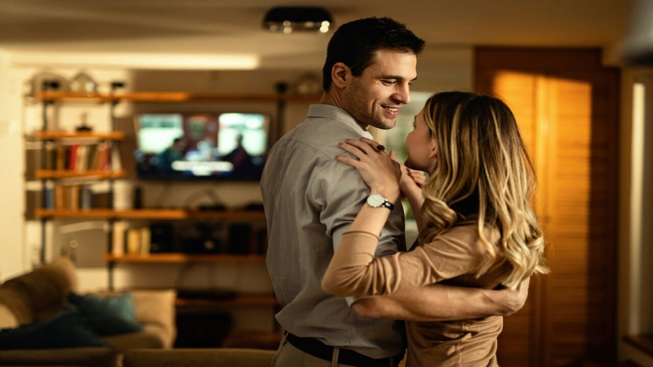 A couple slow dancing at home.