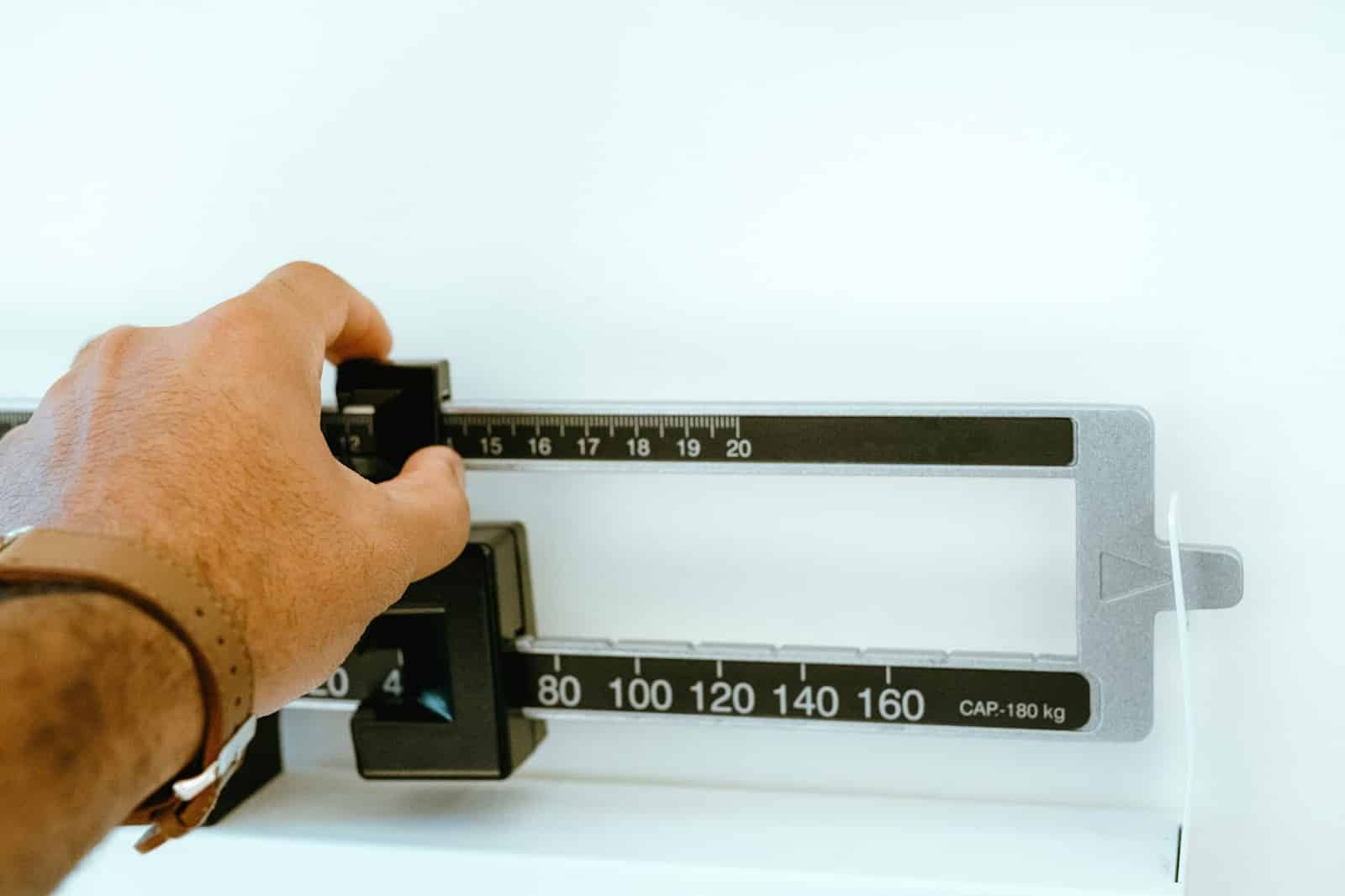 A person checking weight.