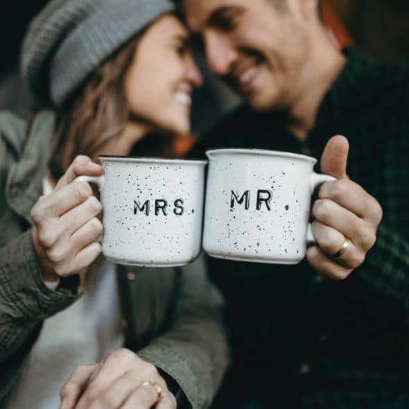 A married couple holding a cup