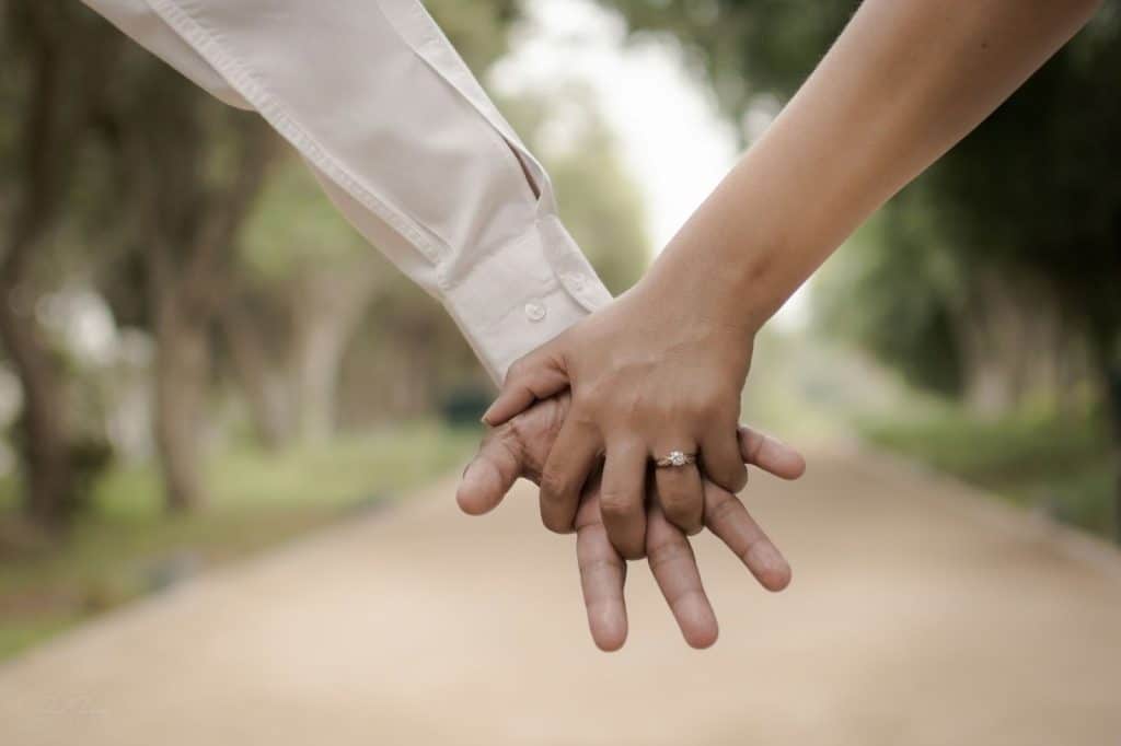 A man and woman holding hands