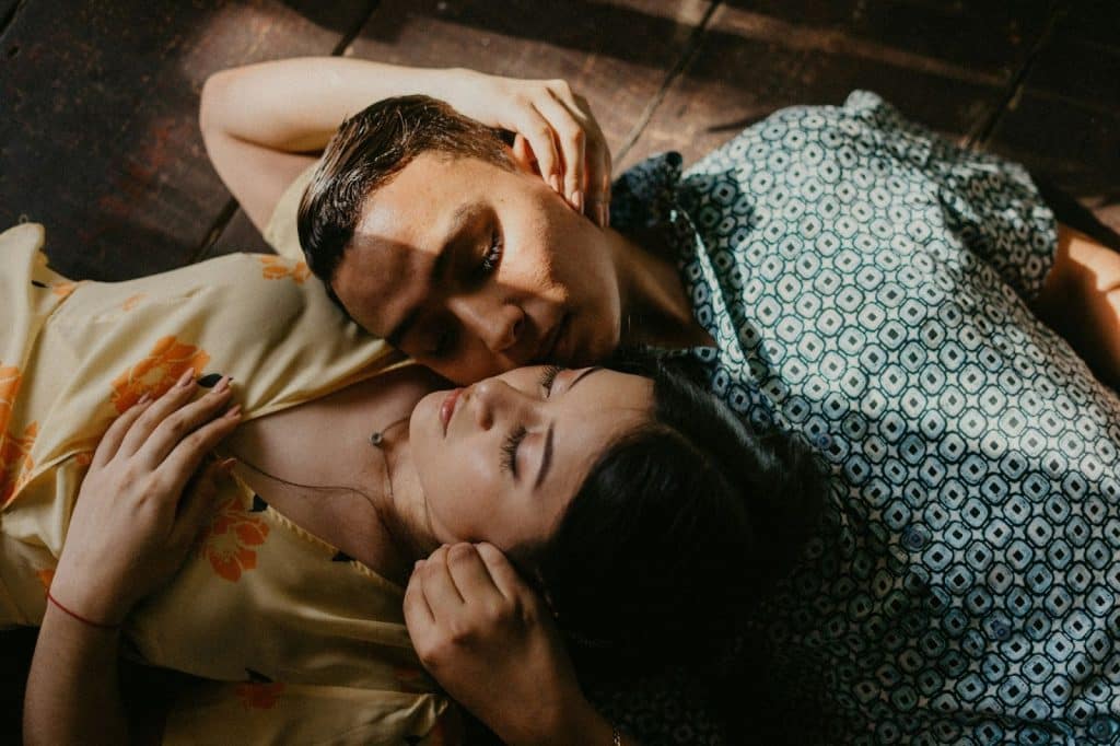 A man looking at his wife sleeping