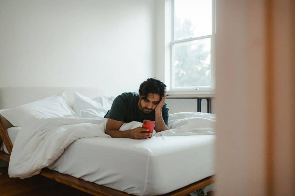 A man having a fatigue while using cellphone