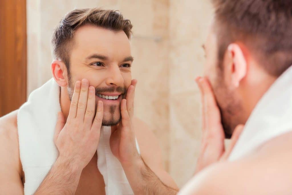 A man looking at the mirror