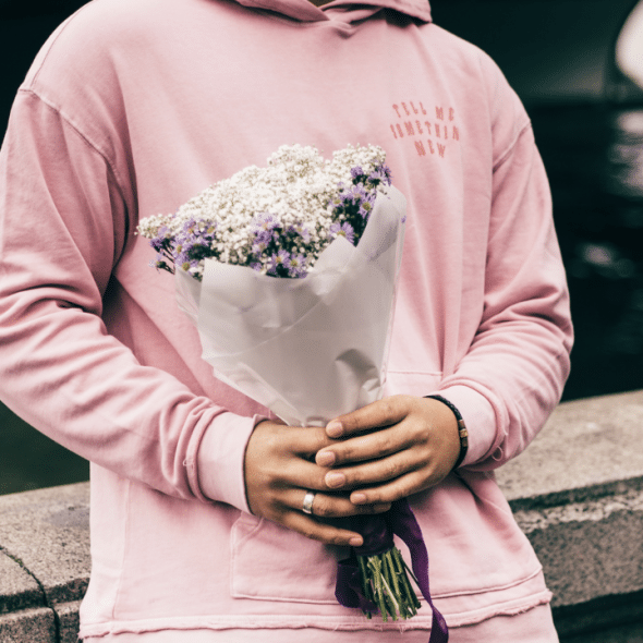 A man holding a bouquet of flowers.