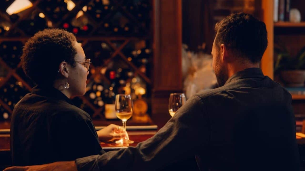 Couple avoiding eye contact during dinner.