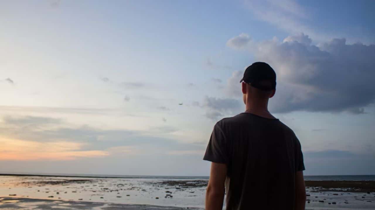 Man relaxing alone while partner is away.