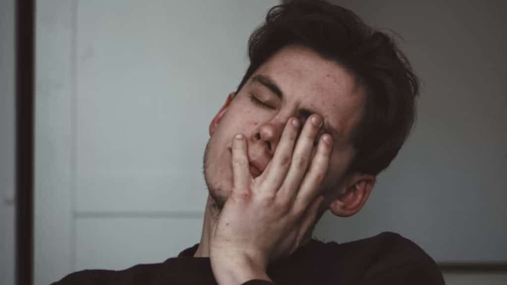 Man resisting emotional expression in a vulnerable moment