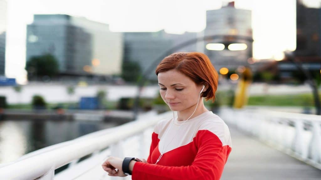 A woman looking at her wristwatch.
