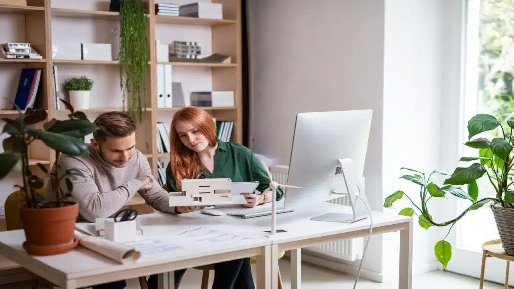 A couple working together indoors.