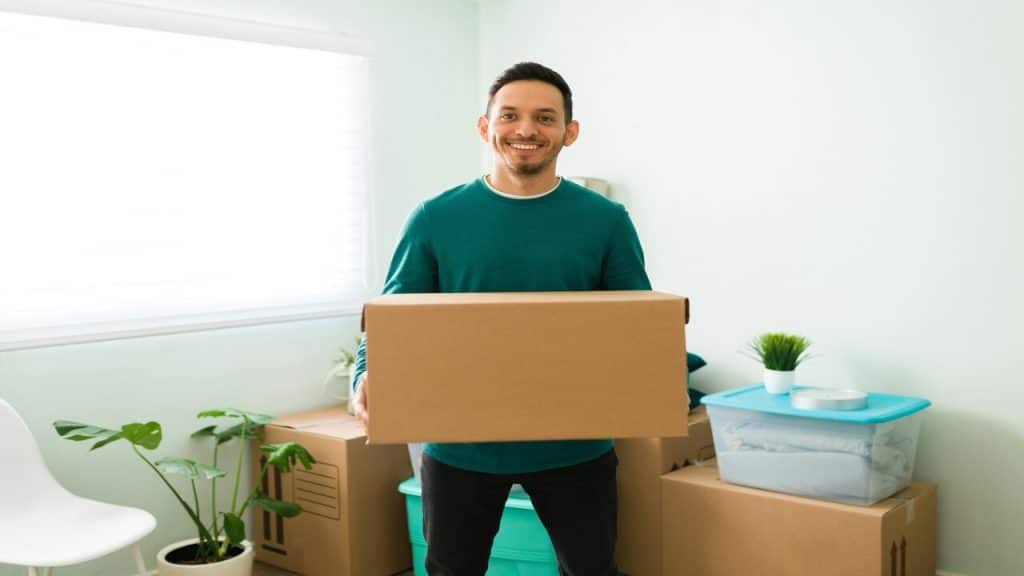 A man carrying a moving box.
