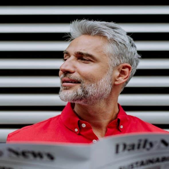 A handsome mature man reading the paper.