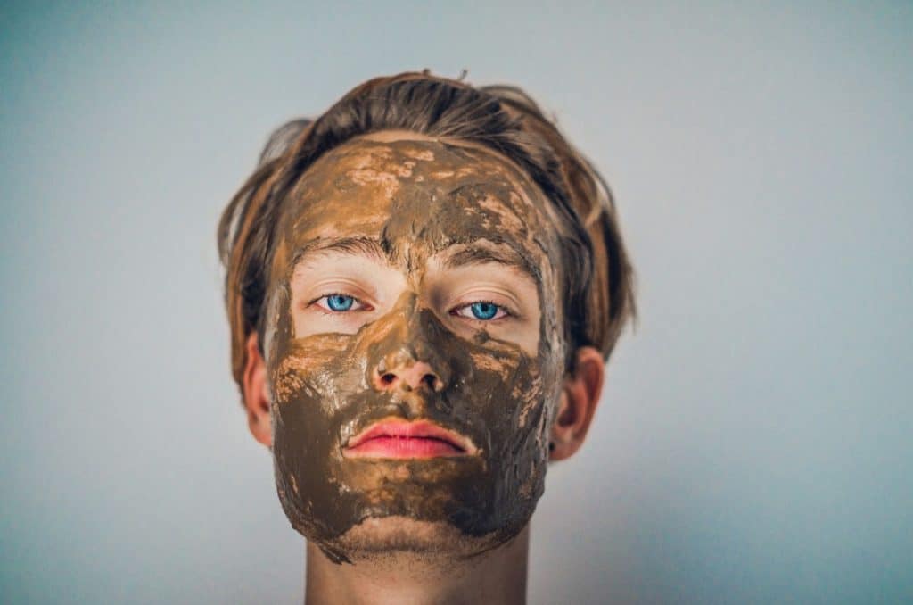 A man using a harsh scrub on face