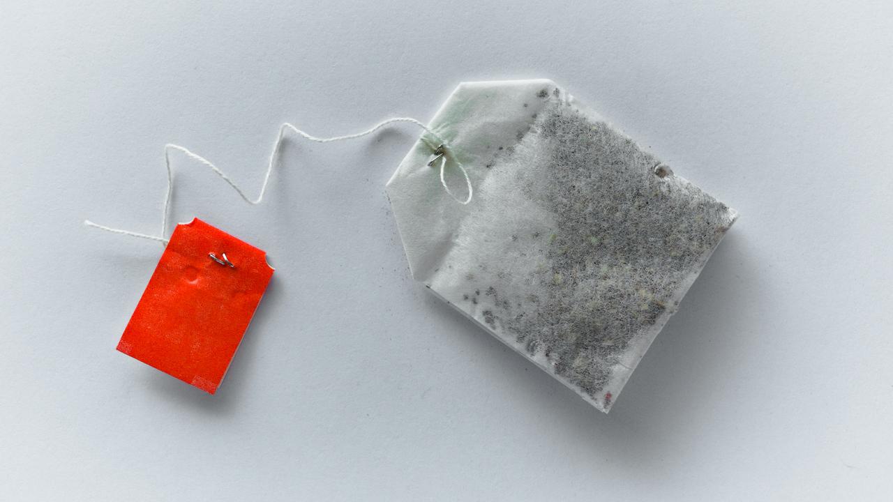 A tea bag with a red tag on a white background.