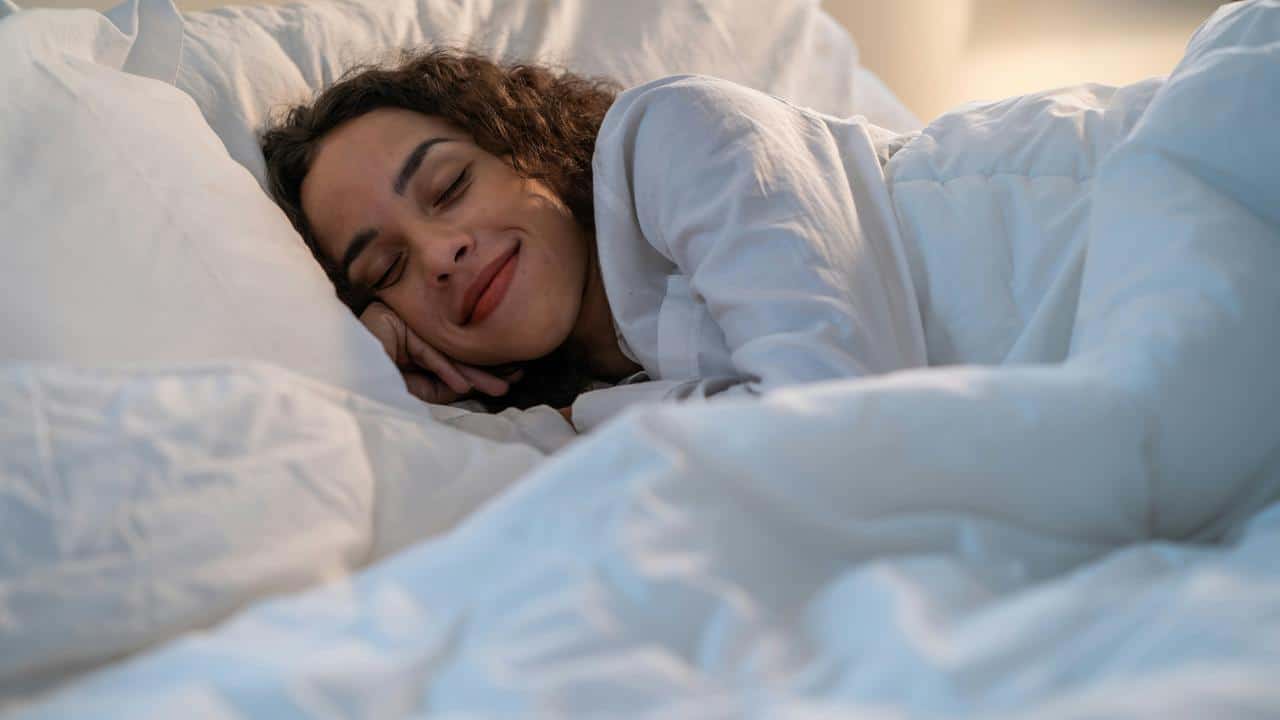 A woman peacefully sleeping in bed.
