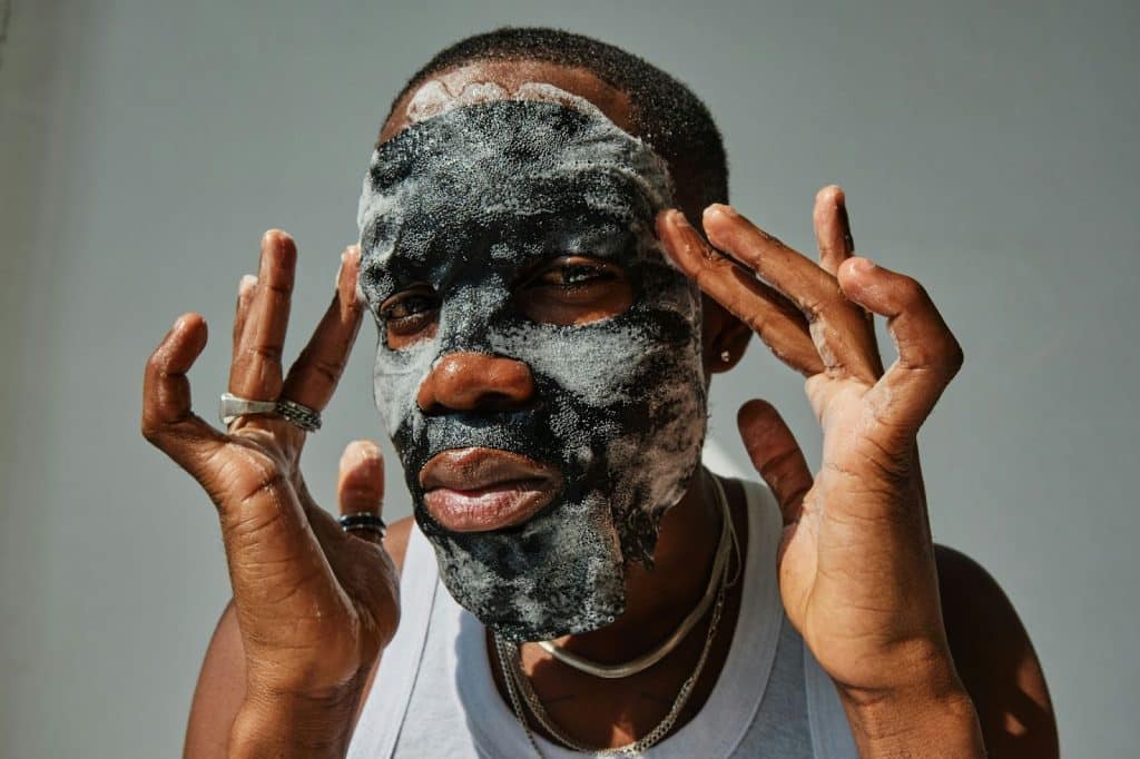 A man starting with facial mask instead of cleansing face