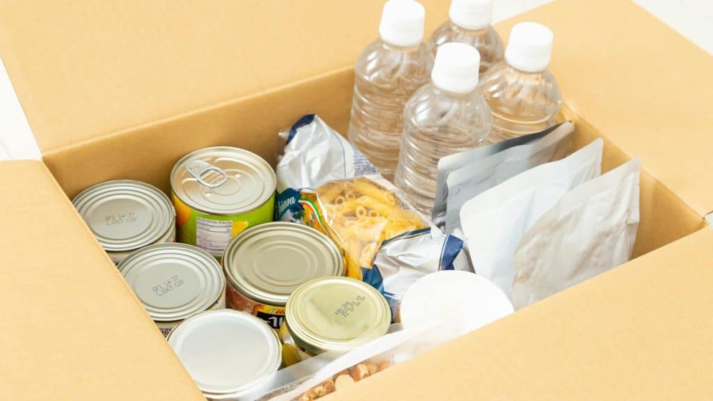 A box of emergency food and bottled water supplies.