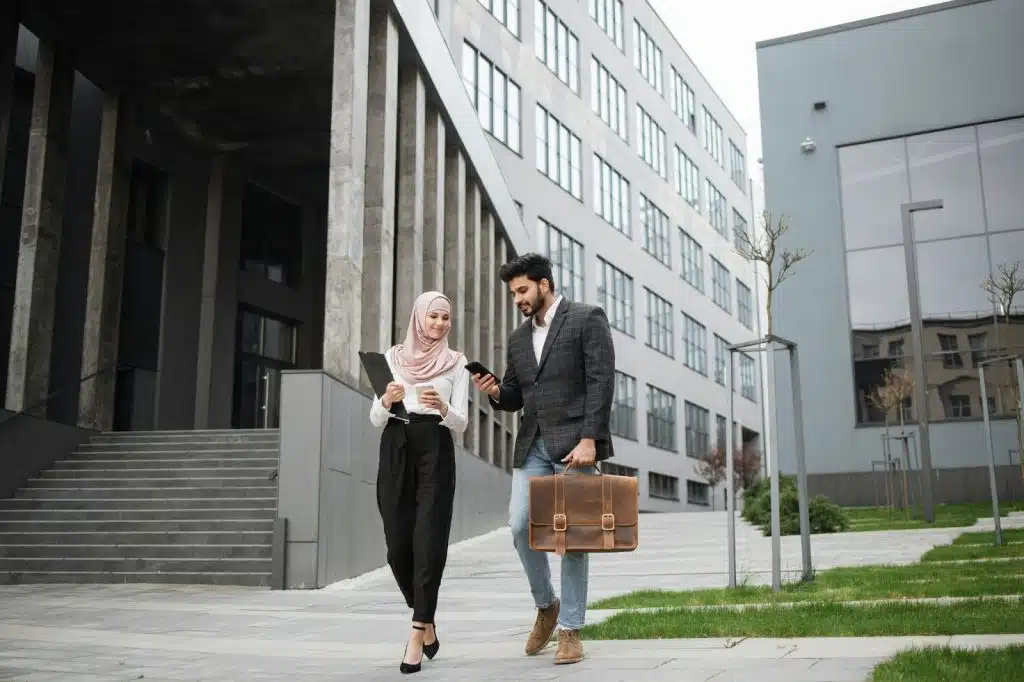 A man and woman walking while having a meeting