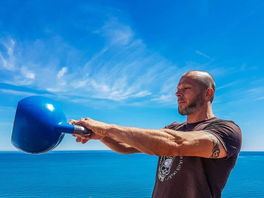 A man holding a kettlebell