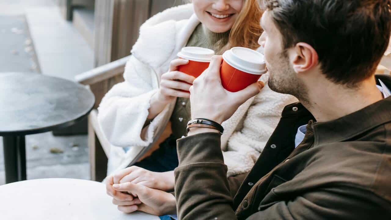 A couple talking over coffee.