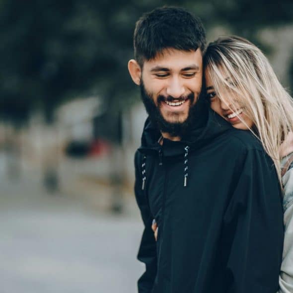 A woman hugging a man