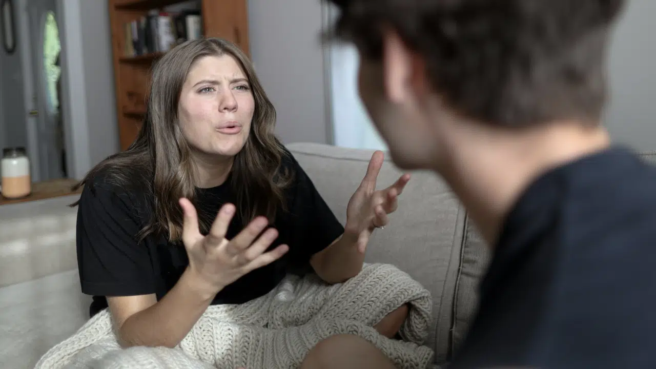 A woman crying while talking to her man.