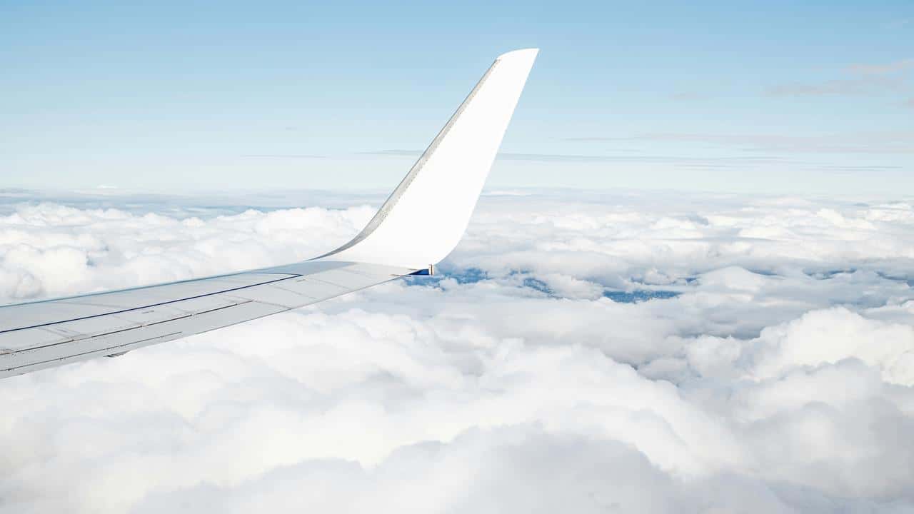 An airplane wing above the clouds.