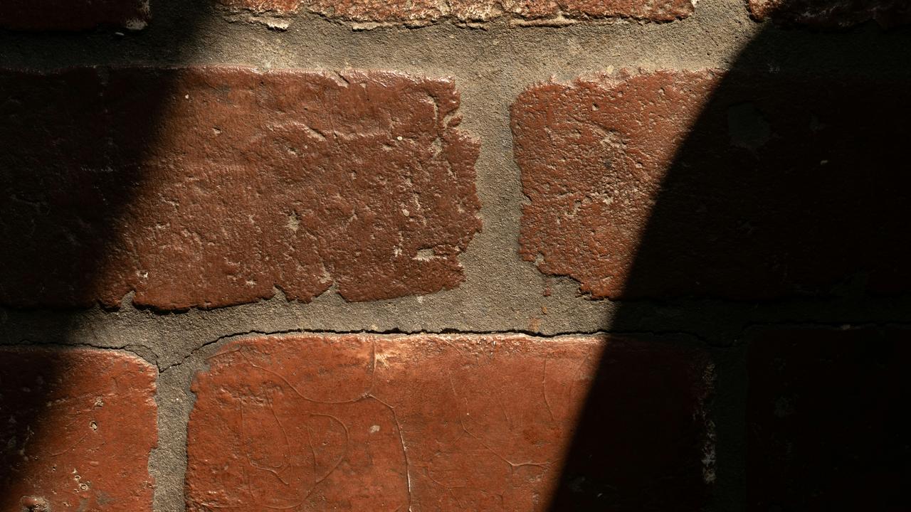 A brick wall in partial shadow.