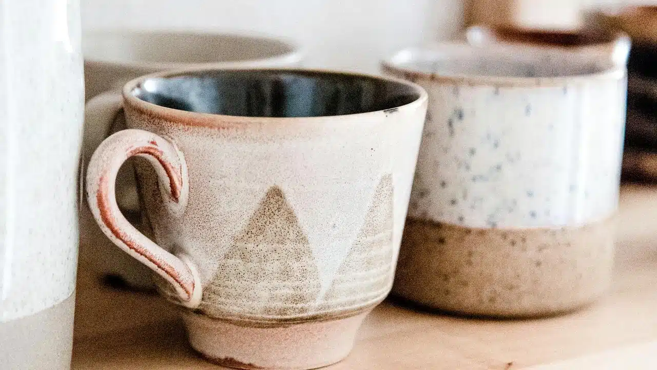 A ceramic coffee mug on a wooden surface.