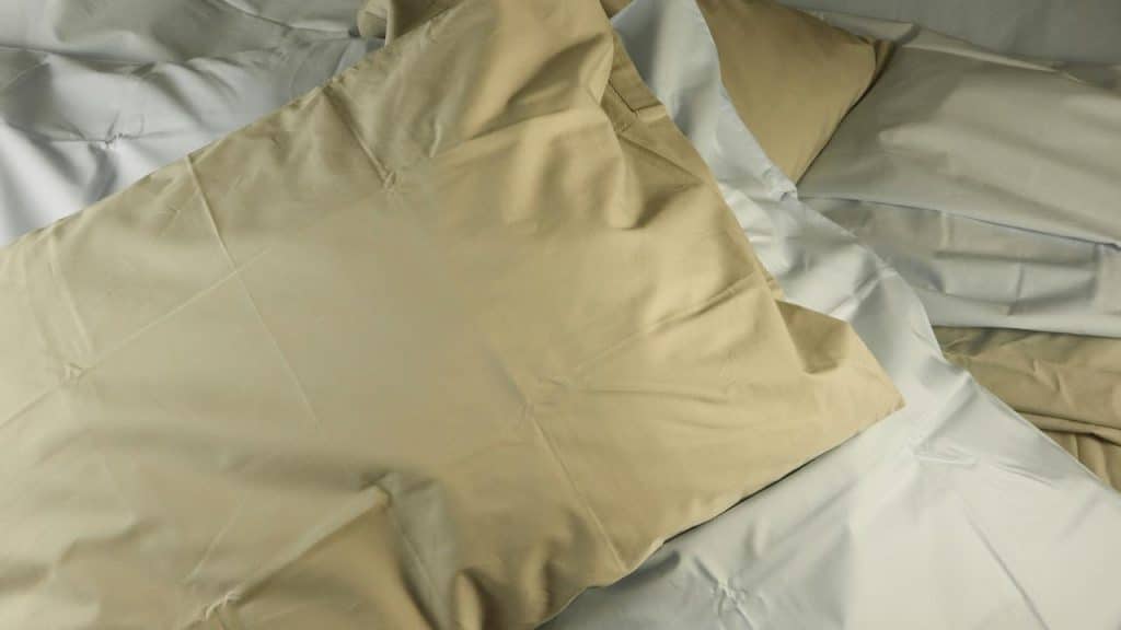 A photo of a bunch of pillowcases on top of a bed.