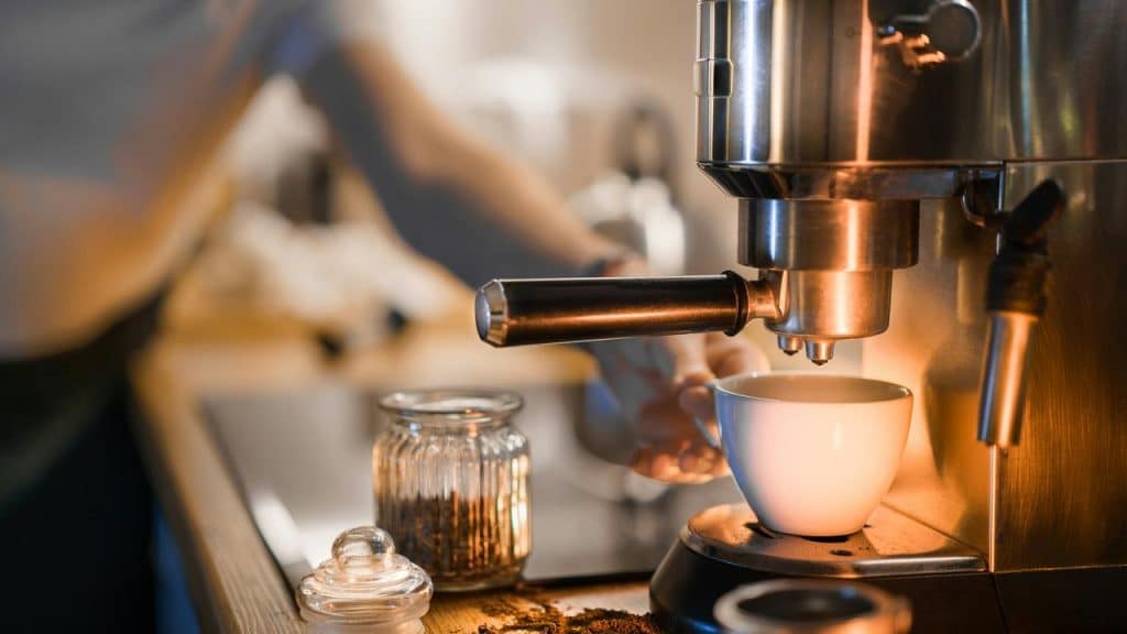 A coffee machine dispensing coffee into a cup.