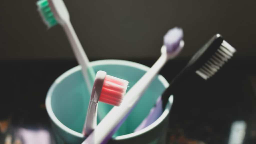 A bunch of toothbrushes inside a mug.