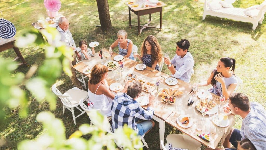 A group of people enjoying a meal together at an outdoor gathering.