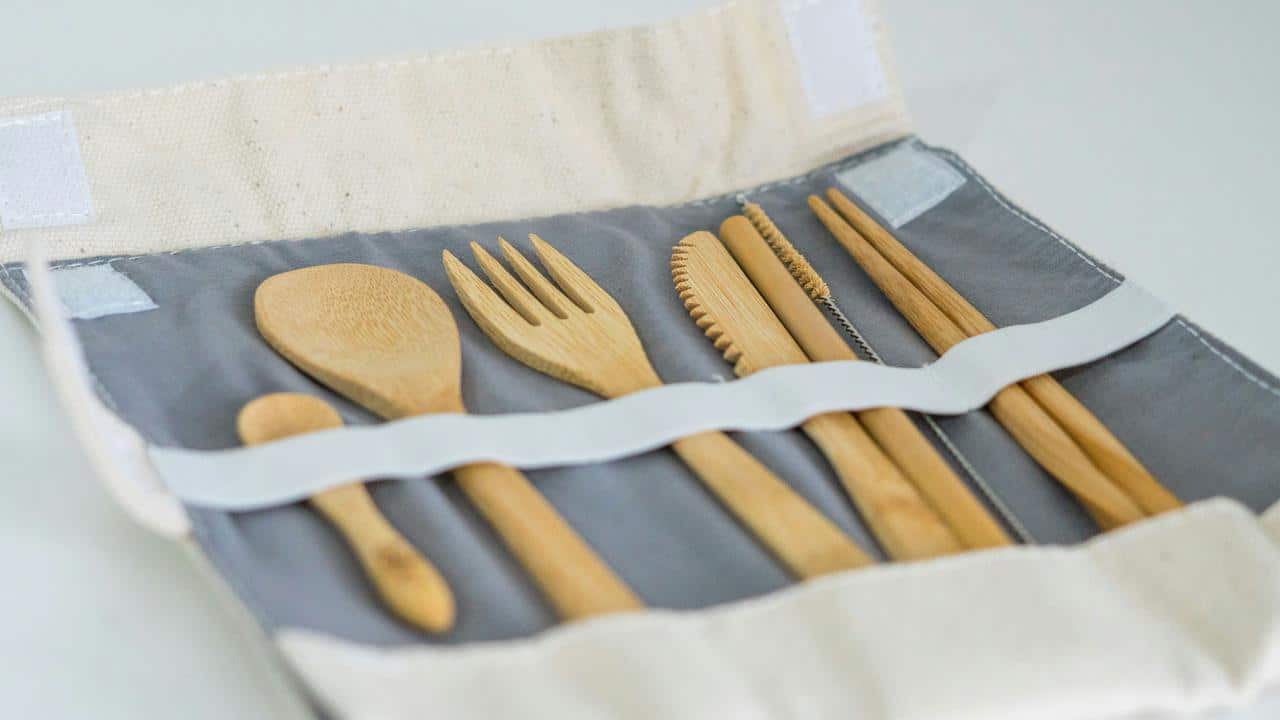 A set of bamboo cutlery in a fabric pouch.