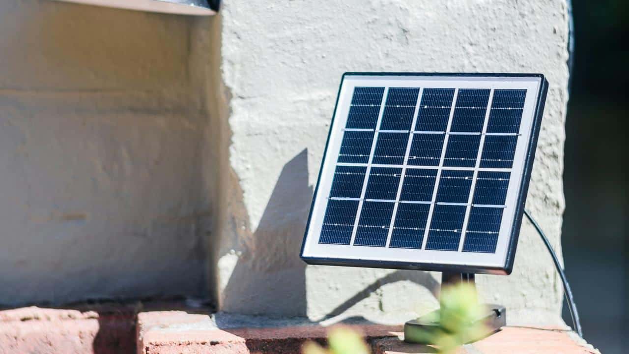 A small solar panel mounted on a wall outside.