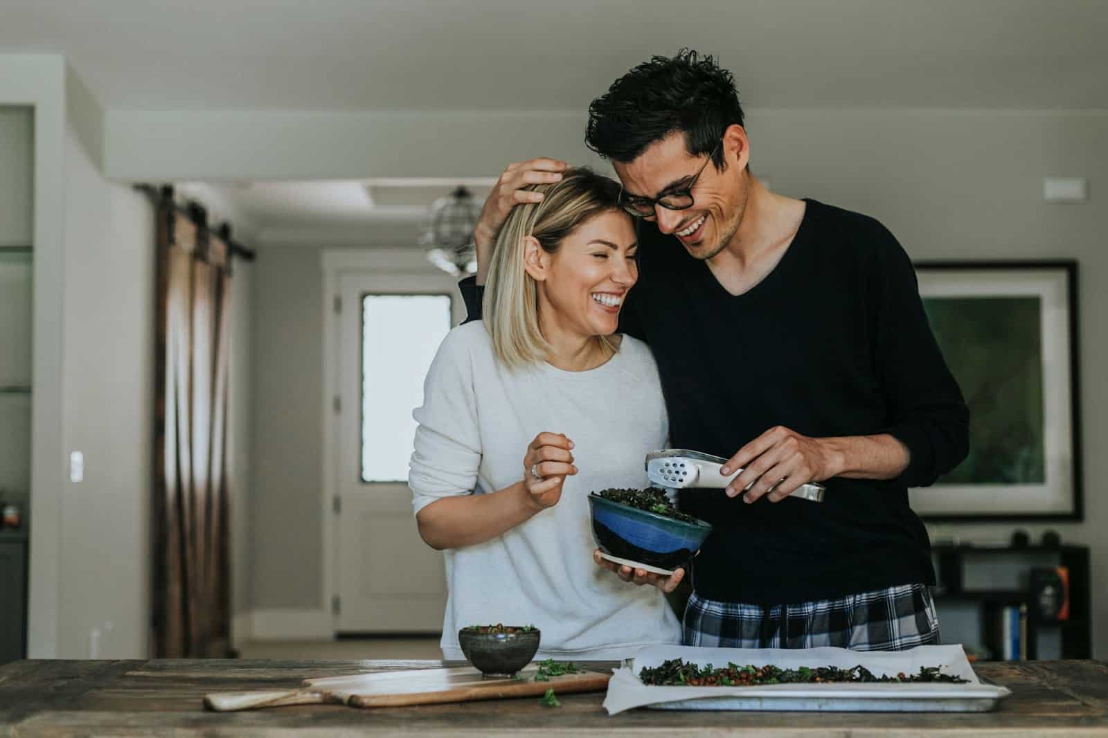 A man and woman cooking together.