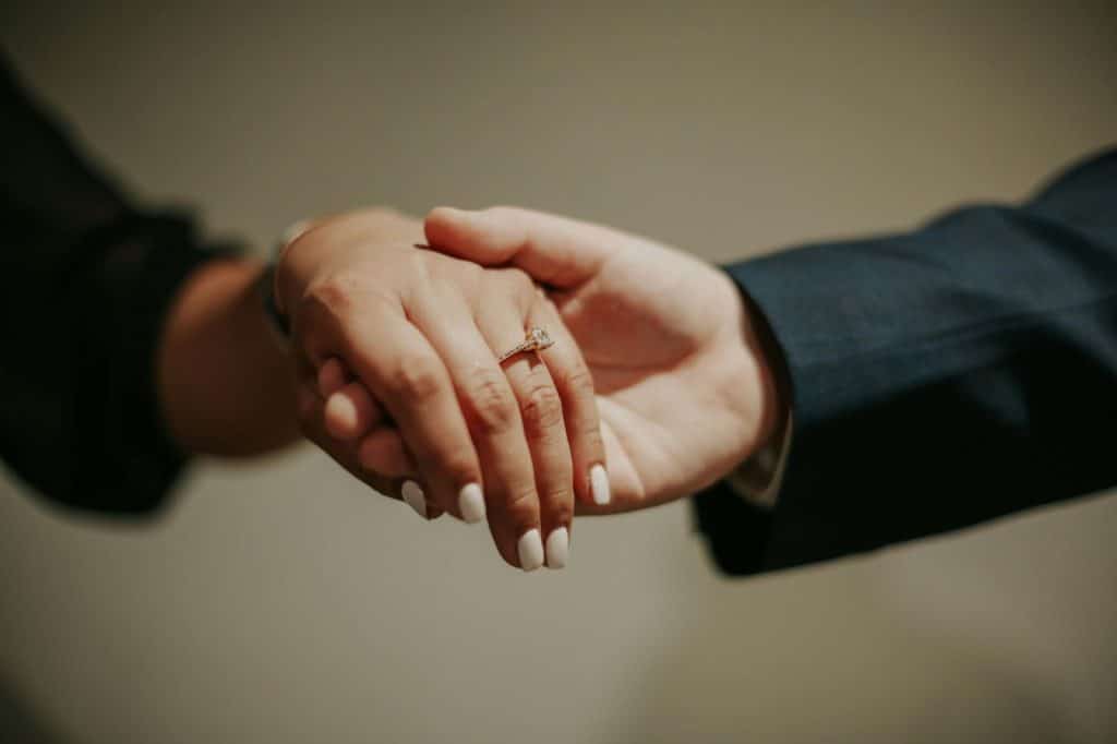 A man and woman touching hands