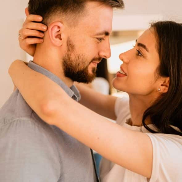 A woman hugging a man