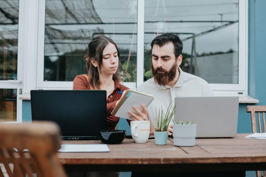 A man serious and listening to a woman