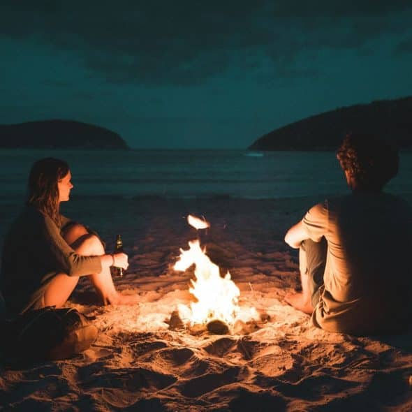 A man and woman having bonfire