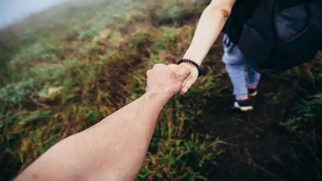 A woman leading a man on a hike