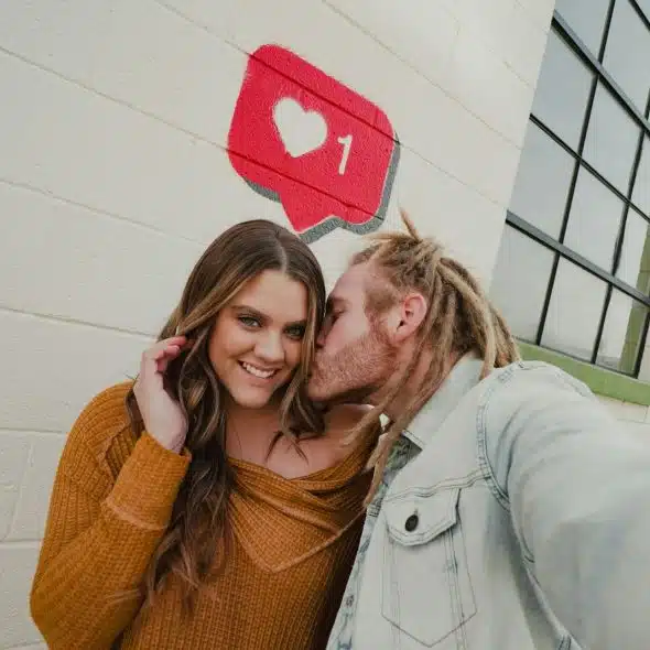 A man kissing a woman’s cheek.