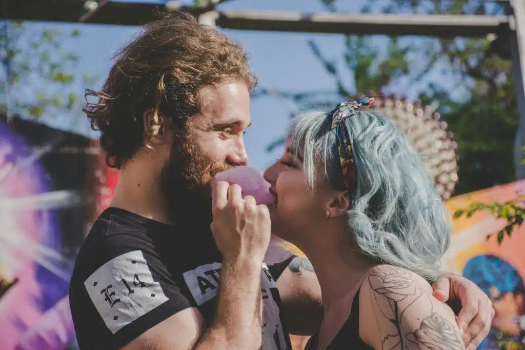 A man and woman eating a cotton candy.