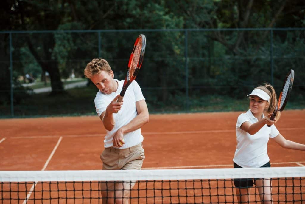 A man and woman playing a tennis together.