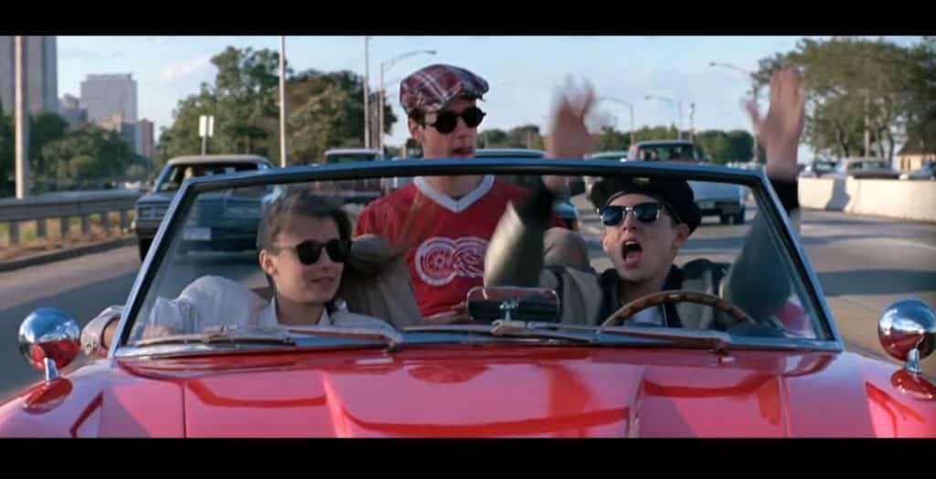 Two men and a woman in a car.