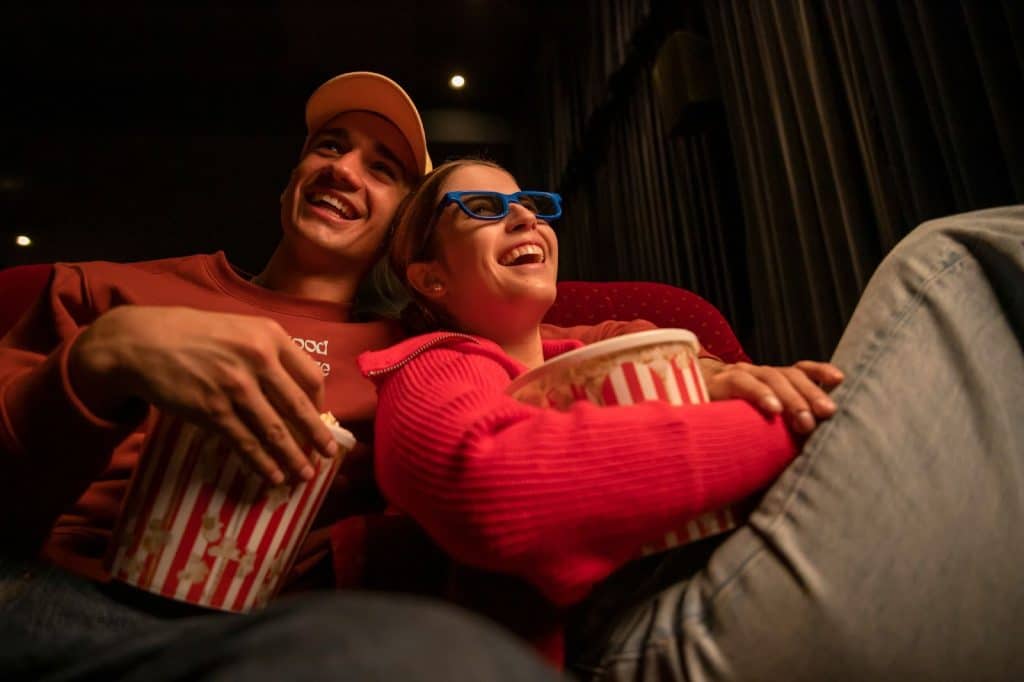 A man and woman watching a movie.