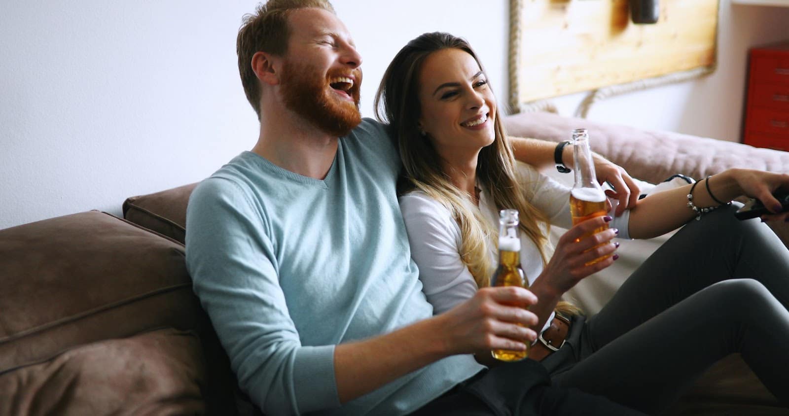 A man and woman drinking beer as a celebration.