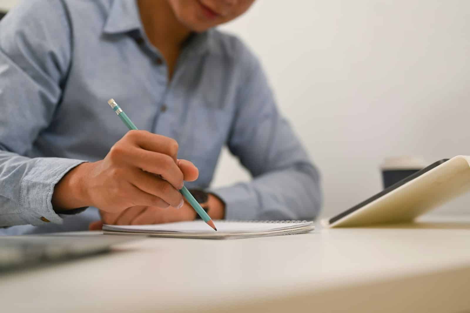 A man writing  a note.