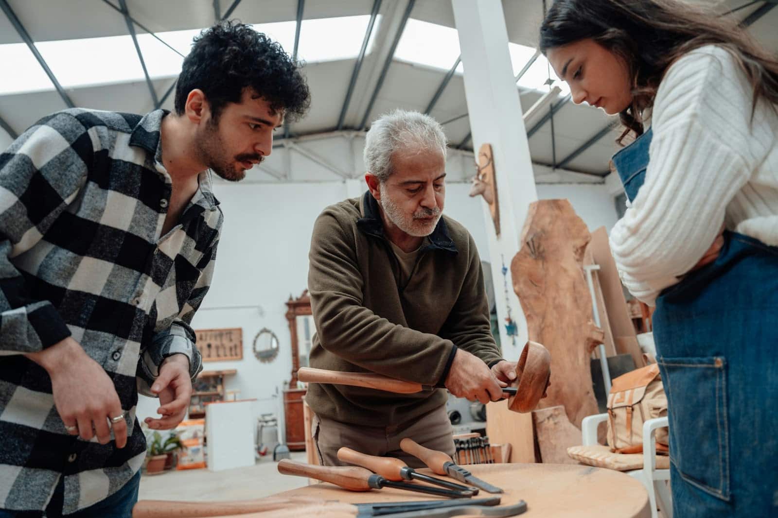 A man and woman having carpentry lessons.